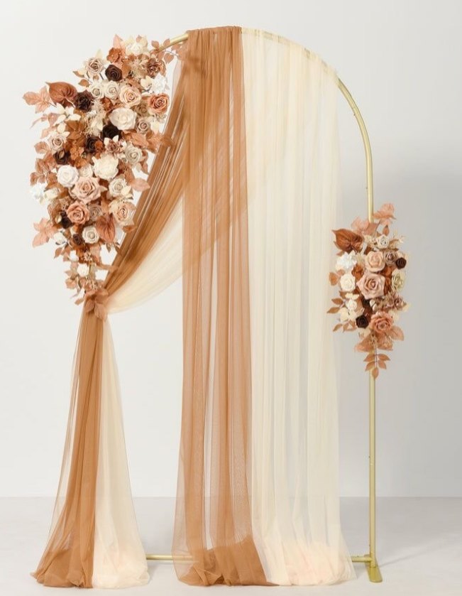 Gold ceremony arch draped in terracotta and cream chiffon with blush, white and burnt-orange rose swags